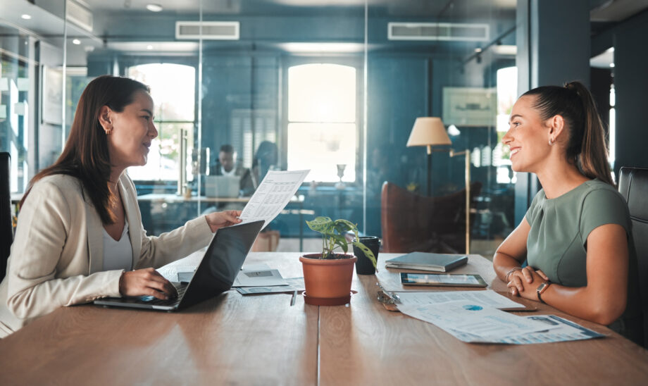 Job interview for a business woman at a hiring company talking to the HR manager about the role or position. Young female applicant or candidate in a meeting with an employer having a discussion.